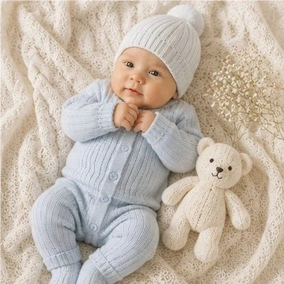 Bébé en ensemble bleu ciel avec son doudou
